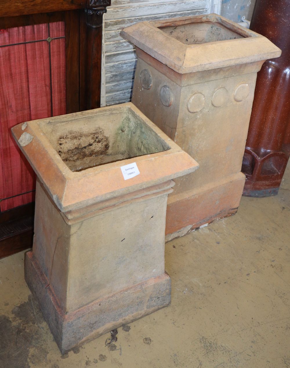 J M Blashfield, Stamford. Two buff chimney pots, c.1880, with roundel decoration, larger W.40cm, D.34cm, H.73cm